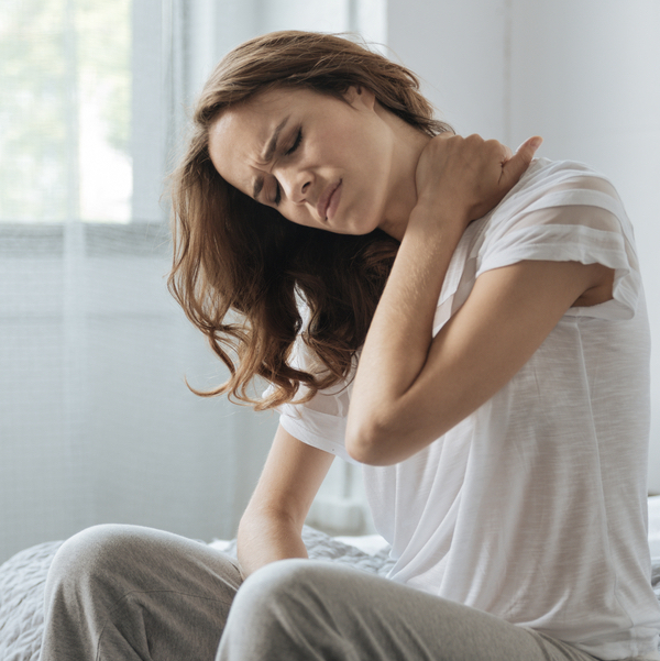 Woman holding her neck in pain