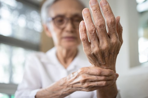 Older lady holding her wrist in pain
