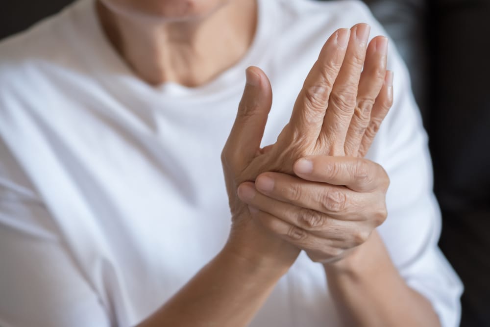 Elderly lady suffering arthritis in hand