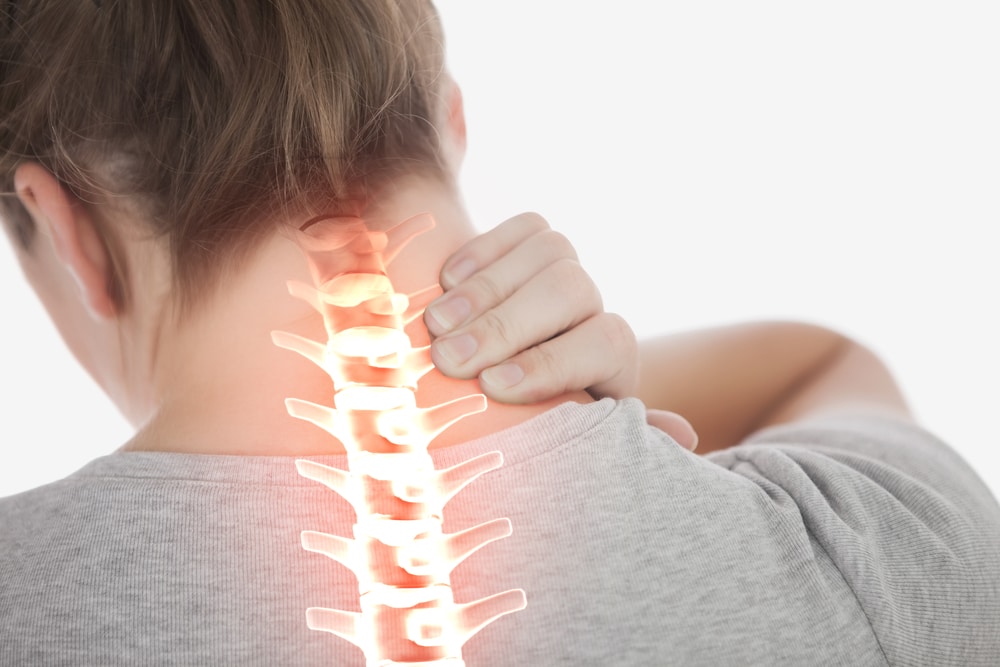 Woman with neck pain, spine emphasised